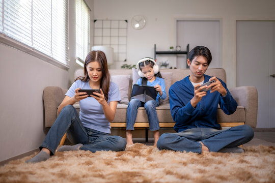 Family using digital devices ignoring each other