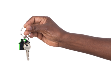 Hand holding a key to a house or an apartament isolated on white or transparent background