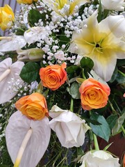 Bouquet of flowers that includes lilies, roses, and baby's breath.