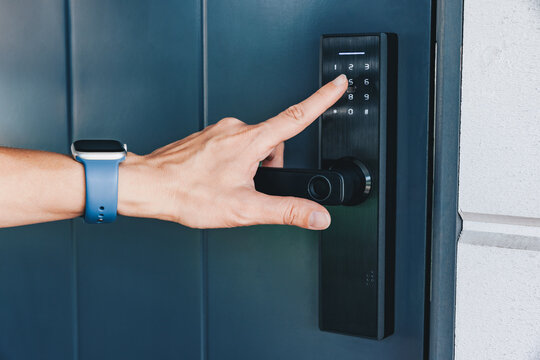 Woman's hand opening and closing the house with fingerprint scan. NFC Technology, keycard, PIN number, Fingerprint scan, smartphone, electrical and contactless concepts