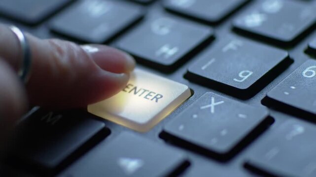 Closeup of a finger pressing the glowing enter key on a modern backlit computer keyboard symbolizing confirmation submission or starting a new digital process in a technologydriven environment. - Powered by Adobe