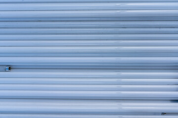 Obraz premium A pile of decommissioned old neon tubes is lying outside. Background.