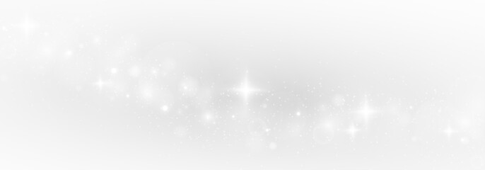 Twinkling stardust and glittering lights spread over a festive Christmas scene.