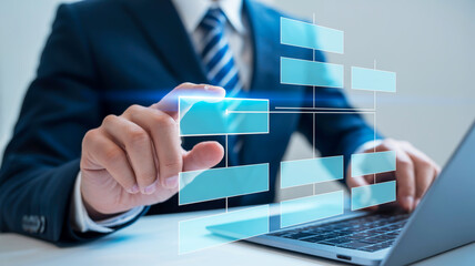 Person in suit interacting with a digital flowchart on a laptop business organization