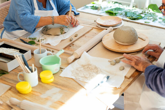 People creating ceramic pottery during workshop