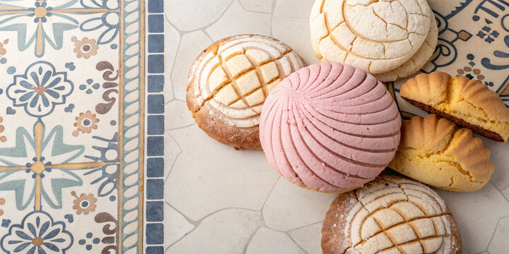 Mexican conchas sweet bread on marble plate and patterned tile suitable for bakery packaging designs traditional cuisine projects culinary branding and promotional food visuals