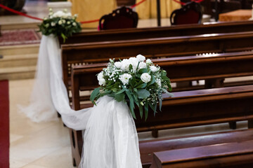 Wedding decorations with white ribbons and flowers. High quality photo