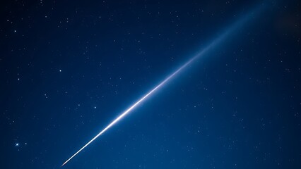 A brilliant meteor streak with a glowing tail in a star-filled night sky.