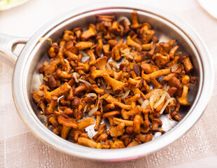 delicious fried chanterelles in a frying pan