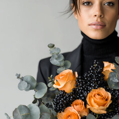 Close-Up of Gothic Floral Arrangement with Black Berries and Orange Halloween Roses