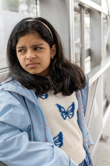 A young girl wearing a blue jacket and a white shirt