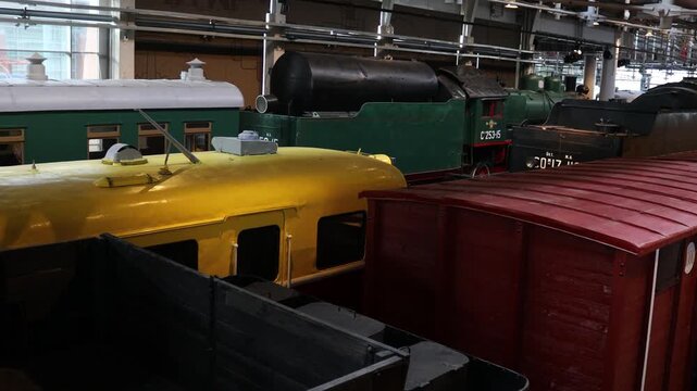 A row of trains standing idle next to each other, ready for their next journey