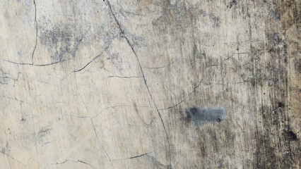A distressed and weathered wooden surface, featuring a grunge texture with deep scratches and dark...