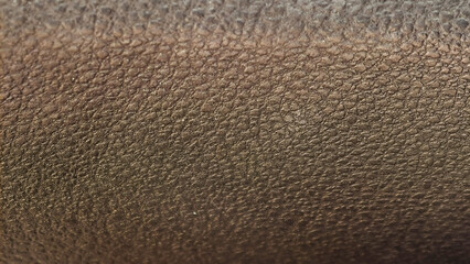 Close-up of a dark brown leather-like texture with a rugged, pebbled surface, showcasing intricate natural patterns ideal for backgrounds or design elements