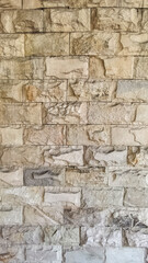 Textured stone walls feature a variety of neutral hues and irregular block patterns. The detailed surfaces and sturdy framework evoke a sense of durability and timelessness