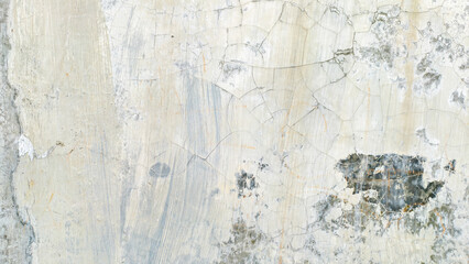 Close-up view of a weathered, cracked, and textured concrete wall surface.