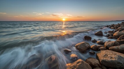 Fototapeta premium Sunset over rocky coastline with breaking waves