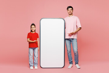 Full body young parent man with child girl wear red casual clothes. Daddy little kid stand big huge...