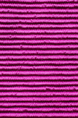 Waves of vibrant pink fabric create a textured masterpiece evoking warmth and creativity in an artistic setting
