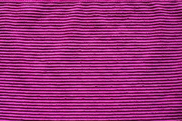 Vibrant purple fabric with textured stripes spreading an artistic flair and warmth