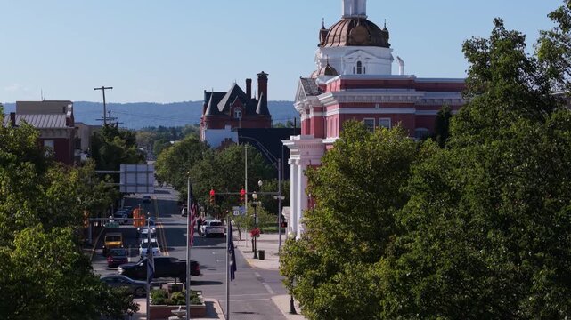 Enjoy stunning aerial views of Martinsburg, West Virginia, showcasing its charming streets and historic architecture on a sunny autumn day.