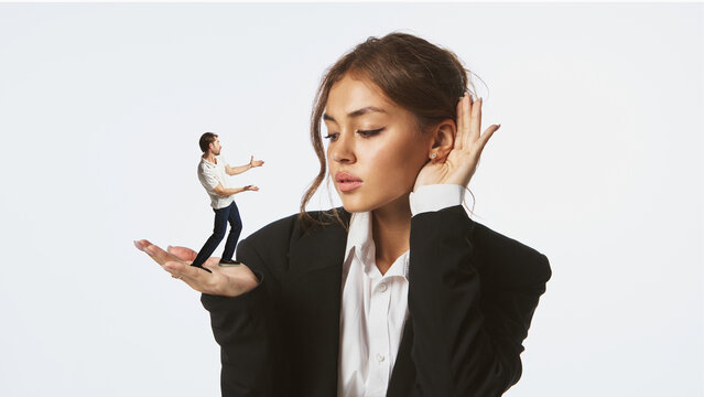 Woman listening to tiny man standing on her palm with thoughtful expression. Concept of communication, empathy, and leadership across gender studies, psychology, and editorial illustration.