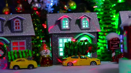 A red house rotates against the backdrop of a Christmas village