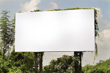 Billboard on rural area of India, outdoor advertising, mockup billing board in front of green tree and Blank white background for branding design large hoarding. Outdoor advertising construction.