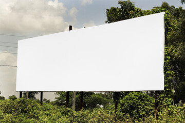 big Billboard on rural area of India, outdoor advertising, mockup billing board in front of green tree and Blank white background for branding design large hoarding. Outdoor advertising construction.