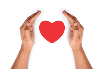 Hands covering heart of red. meaningful image. on white background.
