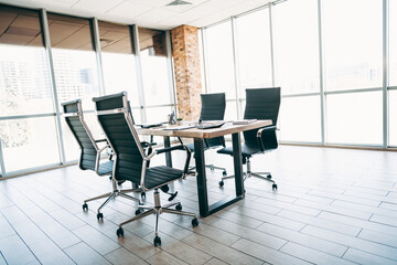 Modern workspace of elegance featuring an executive desk and chairs in a sunny corporate office setting with city view