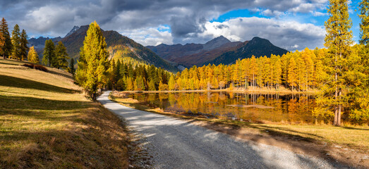 Panoramic autumn view of Lac de Roue in the Queyras Regional Natural Park, Hautes Alpes, French...
