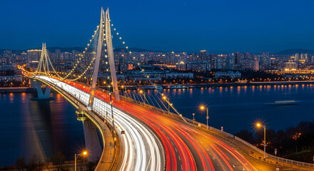 Obraz premium The nanjing dashengguan yangtze river bridge is illuminated at night, with light trails from passing cars in jiangsu province, china