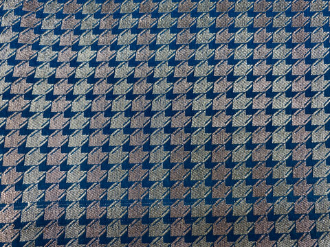 A rich blue and silver geometric woven brocade showcasing intricate patterns with a refined, luxurious sheen.