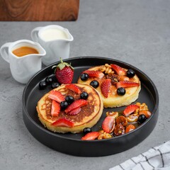 Fluffy Pancakes with Strawberries, Blueberries, and Nuts