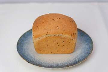 Bread plate blue Fresh loaf of bread isolated on white, top view