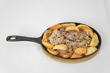 Beef bourguignon meat stew with vegetables and mushrooms skillet over black slate, stone or concrete background , traditinal dish of french cuisine. Top view with copy space.