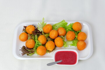 Cheese balls salad Fried cheese sticks in pan with rosemary