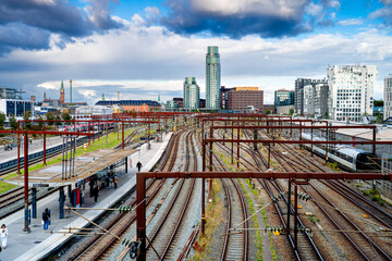People on Dybbølsbro platform in Copenhagen, modern district Vesterbro, Denmark. Panorama of city with railway station.