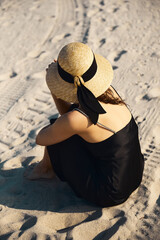Young woman in slip dress enjoying a sunny day on Miami beach