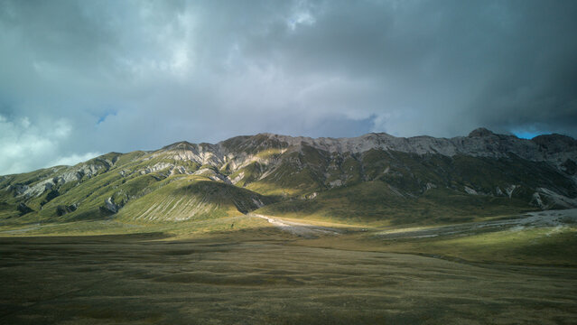 Aerial drone footage of Campo Imperatore, Abruzzo, showcasing vast mountain plains, rocky landscapes, and breathtaking high-altitude scenery - Powered by Adobe