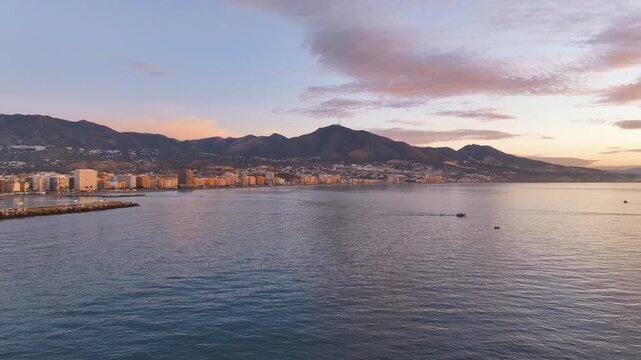 Break of day flight at Spain's famed Los Boliches seafront with boats Fuengirola