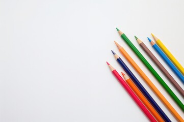 Fototapeta premium Return to classroom: vibrant colored pencils on a bright surface with empty space. Education and learning theme.
