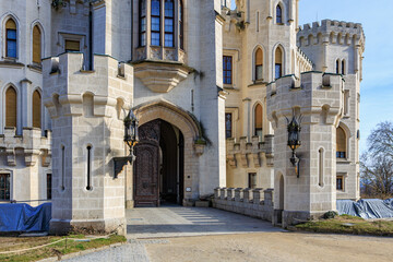 Obraz premium Majestic medieval stone castle entrance with towers and large wooden door
