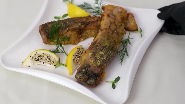 Fried fish lemons breaded fish with dipping sauce and lemon