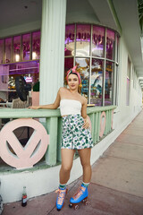 Young woman enjoying summer vibes on roller skates near vibrant cafe setting