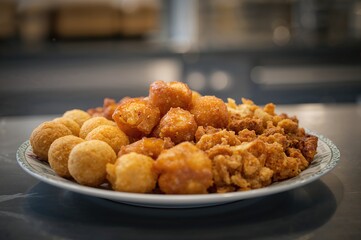 Variety of hot traditional Filipino street snacks including Kwek Kwek, Fish balls, Kikiam, and Tokneneng served on a plate