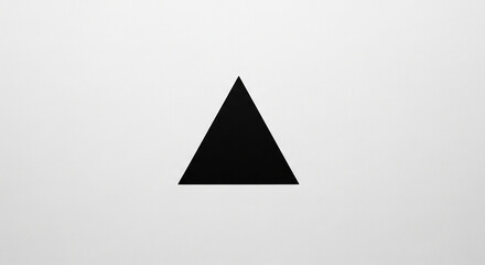 A solid black triangle shape centered on a textured white background, representing geometric form and simplicity