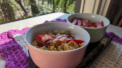 Yogurt with nuts, cereal, strawberry and apple