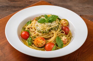 Noodles Tossed in Pesto Sauce with Sweet Cherry Tomatoes and Crisp Green Peppers